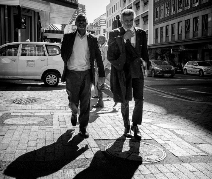 ‘These two men were striding along, both looking very serious, on their way to court. In South Africa, attorneys still wear robes for court appearances, an old-fashioned touch that contrasts well with their modern suits.’