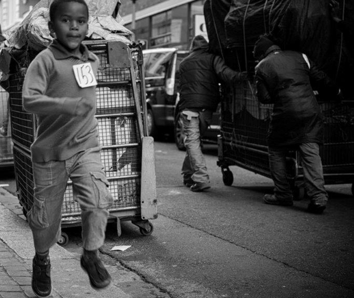 ‘The men in the background are from the market at Greenmarket Square – I like the contrast between them doing their daily toil of pushing their wares up the road and the freedom of the boy running.’