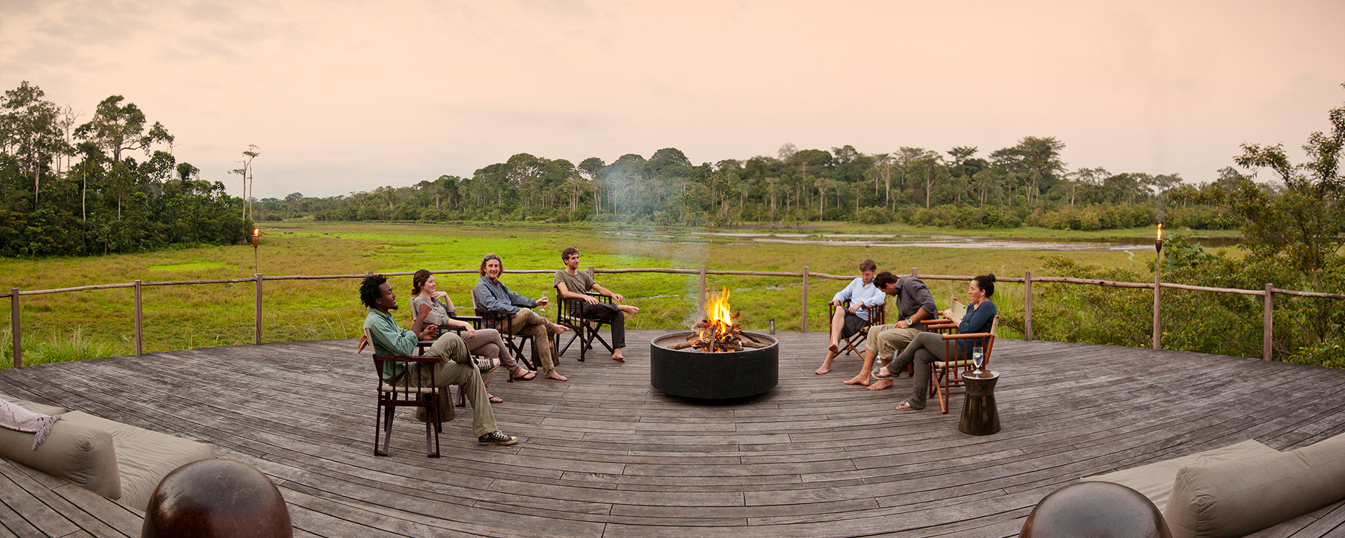 Enjoy balmy evening cocktails on the deck after a day's gorilla trekking at Lango Camp in Congo.