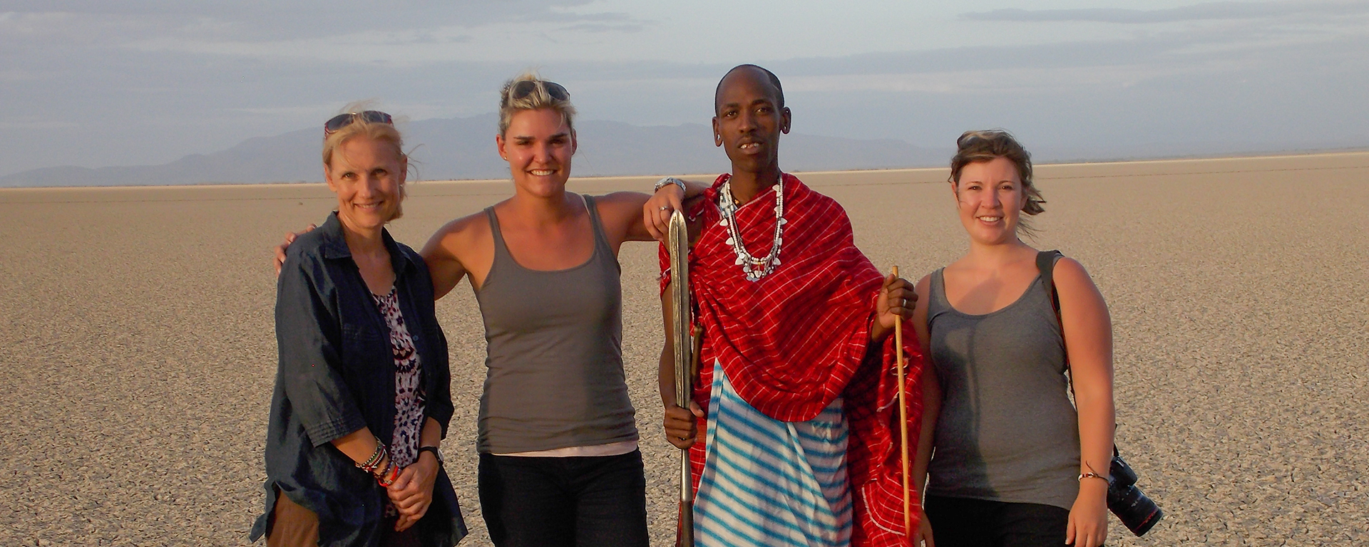 Africa safari experts Anja, Ashley & Mary smile for the camera with their local guide.