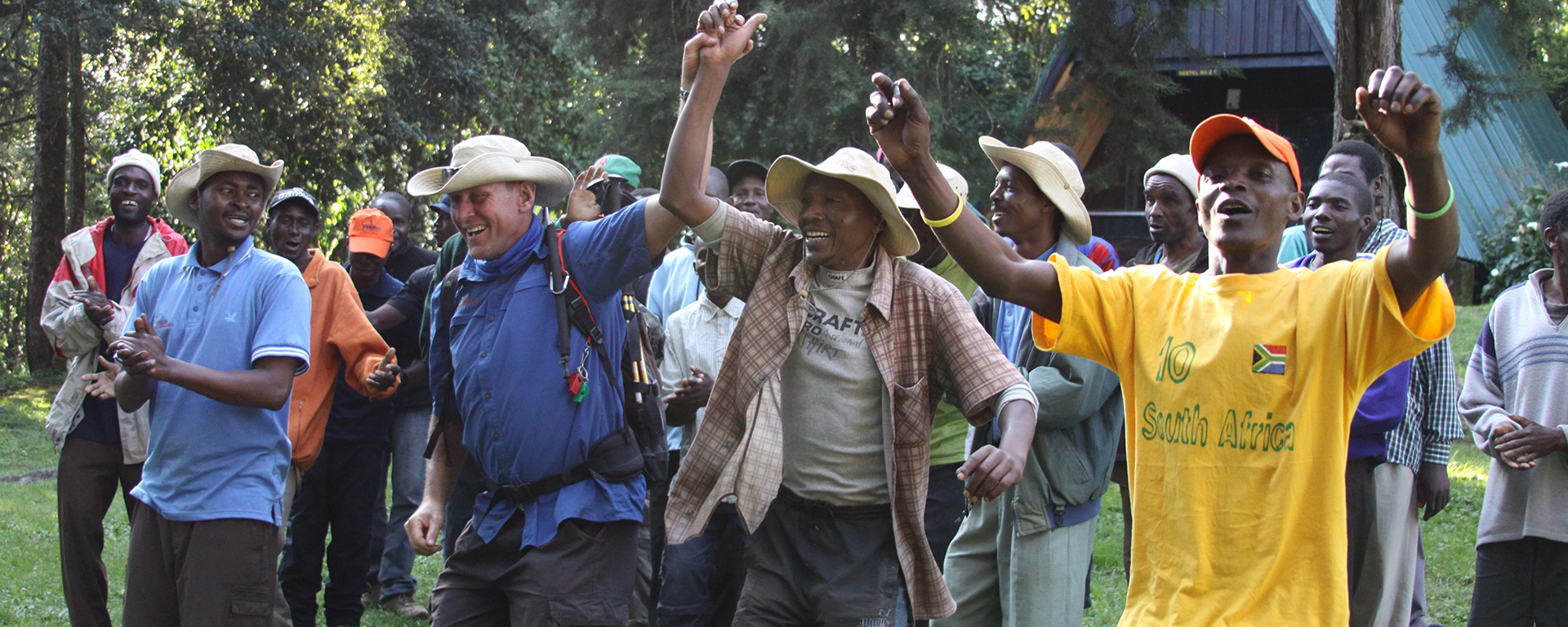 Your Kilimanjaro guides & porters ensure your safety up and down the mountain, worth celebrating at the end!