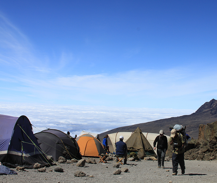 A small army of porters carries every single item - including food, tents & crockery - in your camp up & down the mountain.
