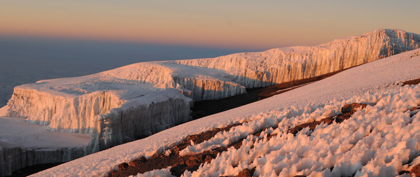 The glaciers near the summit are dazzling as the sun rises over year another day in Africa...