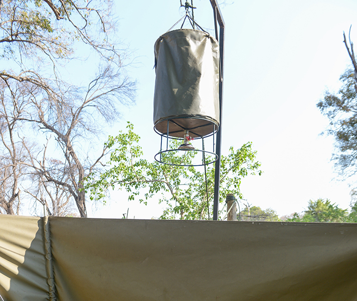 The open-air bucket showers will be refilled by the staff with water heated on the fire...