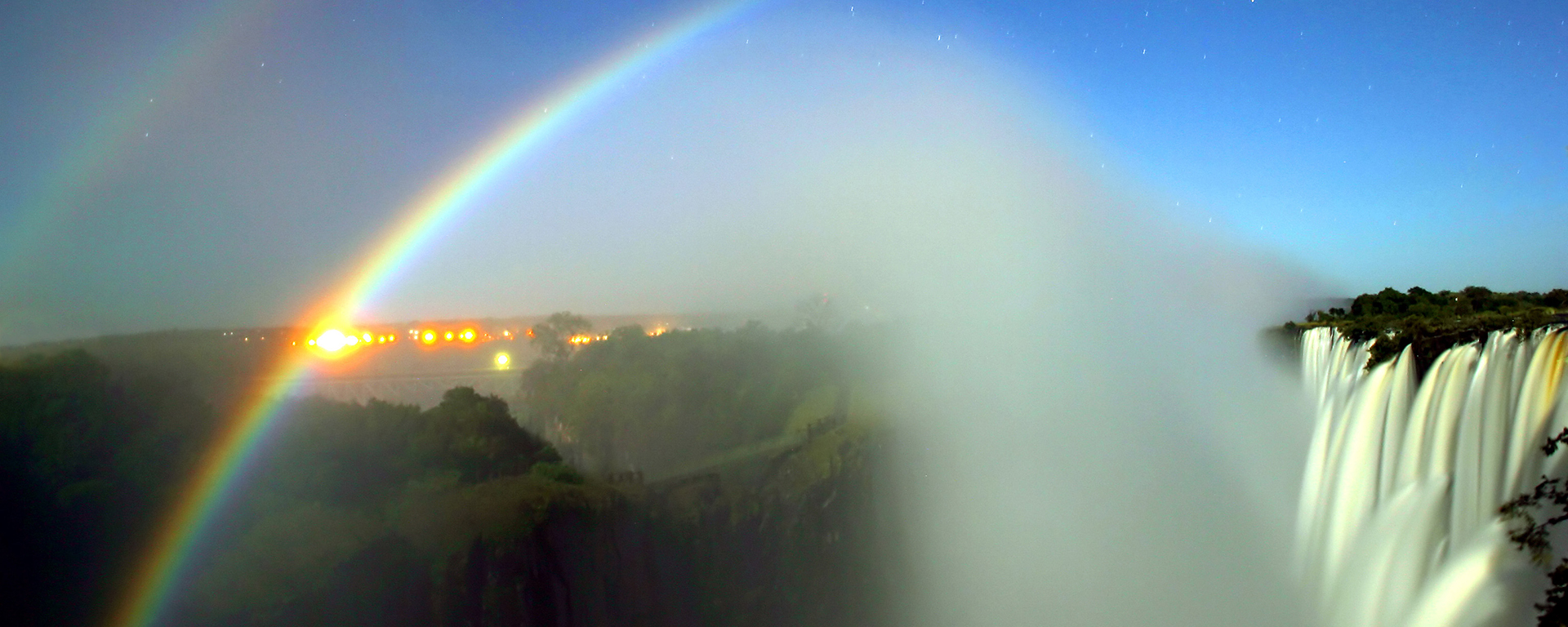 Full flood, full moon & a cloudless night make for 'moonbows' over Victoria Falls. (Photo: WikiCommons/Calvin Bradshaw)