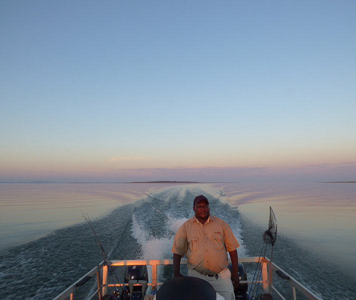 Our captain, Maxwell, expertly guiding us to the best fishing spots on the lake...