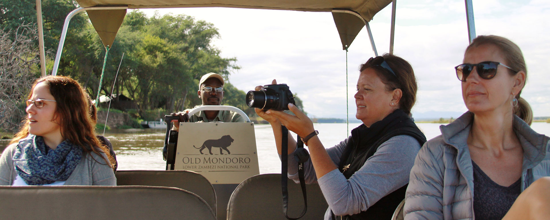 Go2Africans Liesel, Natasha and Rikke enjoying a river transfer from Old Mondoro to Chiawa – herds of elephants are frequently spotted drinking at the water’s edge.