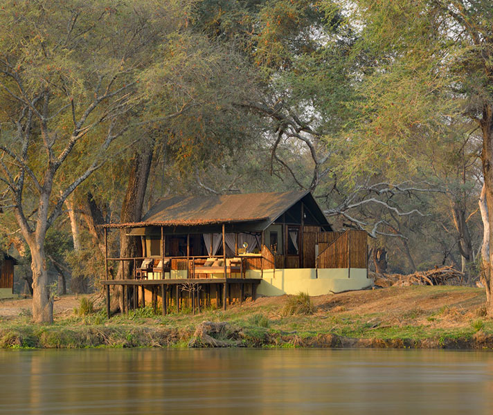 Sheltered by mature trees, Old Mondoro down-to-earth tents that look out over the river or channel.