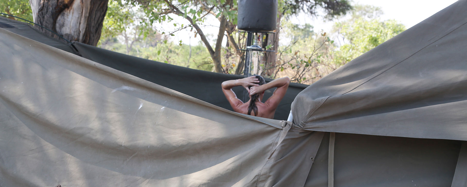 Go2African Angela rinsing off the dust while mobile camping in Botswana.