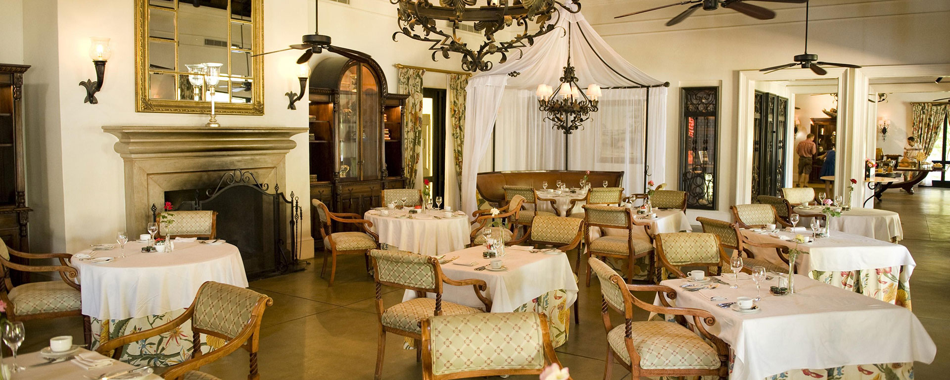 The sumptuous dining room at The Royal Livingstone prides itself on silver service, with plates being delivered under immense cloches.