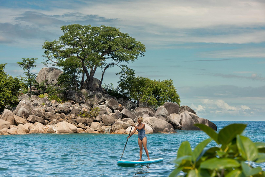 Woman stand up paddling in Lake Malawi, Malawi.