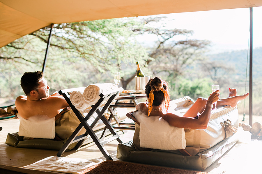 Couple indulging ‌in ‍traditional canvas bush baths at Cottars ‍in Africa.